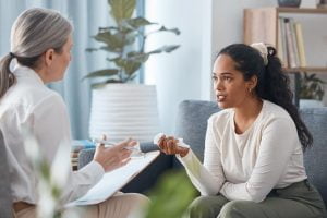 A therapist and a patient discuss transitional aftercare programs