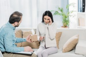 therapist explaining to distraught young woman the 5 tips on handling addiction cravings