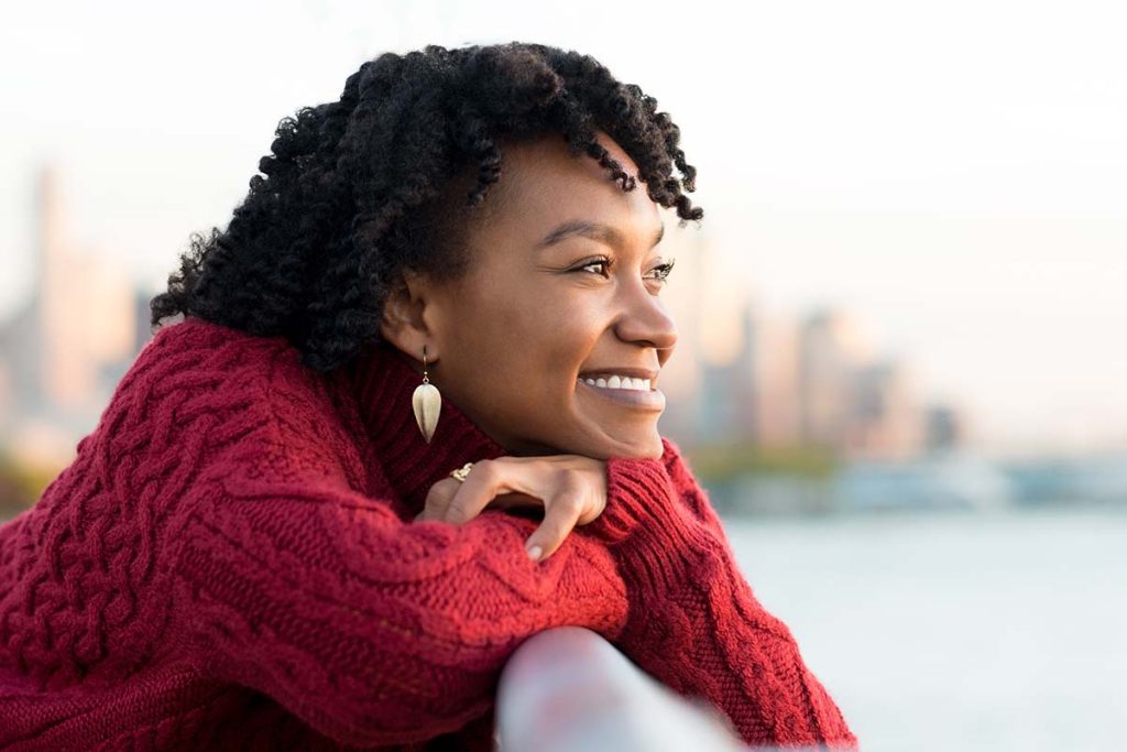 Happy woman thinking about ways to overcome fear in recovery